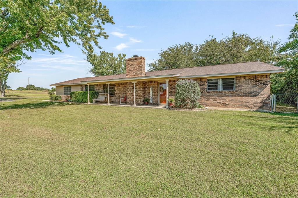 Welcome to your country retreat in one of the area’s most desirable locations! Nestled on nearly 2 acres, this beautiful brick home offers a perfect mix of charm, comfort, and functionality. With 3 spacious bedrooms, 2 bathrooms, a dedicated office, and a unique cabin style sunroom, there’s room for everyone to live, work, and relax. 
Inside this home features over 2500 square feet of living space.  The open living area centers around a cozy fireplace, creating a warm and inviting atmosphere. The kitchen is a standout with a large island, custom wood cabinetry, granite countertops, and a walk-in pantry—ideal for cooking and gathering. The log-accented sunroom adds rustic character and serves as a bright, relaxing space to enjoy year-round. 
Outdoors, you’ll find everything you need for country living. A workshop with electric,  RV storage with hookups, additional storage buildings, and a well for outside watering make this property practical as well as beautiful. The fenced yard is ready for play or animals, and covered parking ensures convenience.
With scenic surroundings and a highly sought-after location, this brick home with its one-of-a-kind sunroom is truly a must-see!