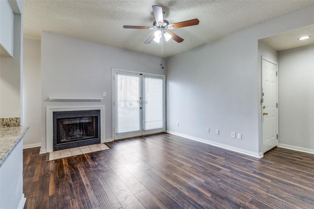Ideally situated just off Skillman Street with quick access to I-635, this charming one-bedroom condo combines comfort, style, and an unbeatable location in the highly sought-after Richardson ISD. Inside, you’ll find attractive wood-look tile flooring and a spacious living area highlighted by a cozy wood-burning fireplace. The kitchen is well-appointed with granite countertops, an electric range, built-in microwave, and ample cabinetry—perfect for both everyday living and entertaining. The generously sized bedroom features a walk-in closet and private access to a tranquil back patio overlooking peaceful natural scenery. The bathroom is equally inviting, offering granite countertops, a medicine cabinet, and a built-in sitting area for added functionality. Step outside to enjoy a private front patio just moments from the community pool. The refrigerator, washer, and dryer are all included, making this home truly move-in ready. Schedule your private showing today and experience everything this beautiful condo has to offer!