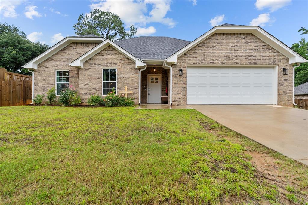 Welcome to this charming 2023-built home nestled in the desirable Riverside U-2 subdivision within highly sought-after Lindale ISD. Offering approximately 1,550 square feet of thoughtfully designed living space, this one-story residence features 3 spacious bedrooms and 2 full bathrooms, all conveniently located on a single level. The inviting exterior showcases a timeless blend of brick and stone, complemented by a clean, well-maintained lot just under a quarter acre. Step inside to discover a comfortable and functional layout with a kitchen and dining combo that creates an ideal setting for everyday living and entertaining. The interior is enhanced by central electric heating and cooling, ceiling fans, and a light, airy feel throughout. With all bedrooms located downstairs, this home provides both convenience and accessibility for a variety of lifestyles.

Outside, enjoy a covered patio perfect for relaxing evenings or weekend gatherings, along with a fully fenced backyard offering privacy and space to unwind. The concrete driveway and front-entry garage provide practical curb appeal and ease of access. Located just minutes from Lindale, this property offers a peaceful setting while maintaining close proximity to shopping, dining, and local amenities. Whether you're a first-time buyer, downsizing, or looking for a low-maintenance investment, this home checks all the boxes with its modern construction and efficient design. With public utilities, a slab foundation, and quality finishes throughout, this property is move-in ready and built for comfort. Don’t miss the opportunity to own a newer home in a growing East Texas community known for its charm and convenience.