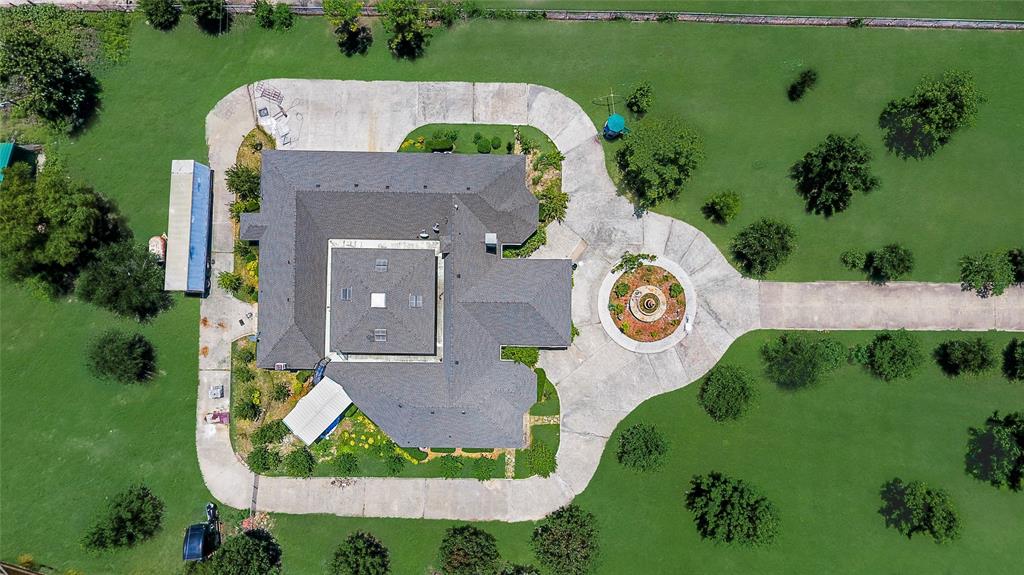 Wonderful investment opportunity for a residence or development.  One of a kind custom home with so many options.  4 bedrooms surround an open living area that has a open atrium feel. The kitchen, dining area and family room are in the back.  A three-car garage and a drive-through porta coche create a more upscale feel to go with the gated entry.  The back half of the property has a barn and is fenced with an ag exemption.  The property next door (MLS#20416636) is also available if a larger parcel is desired.