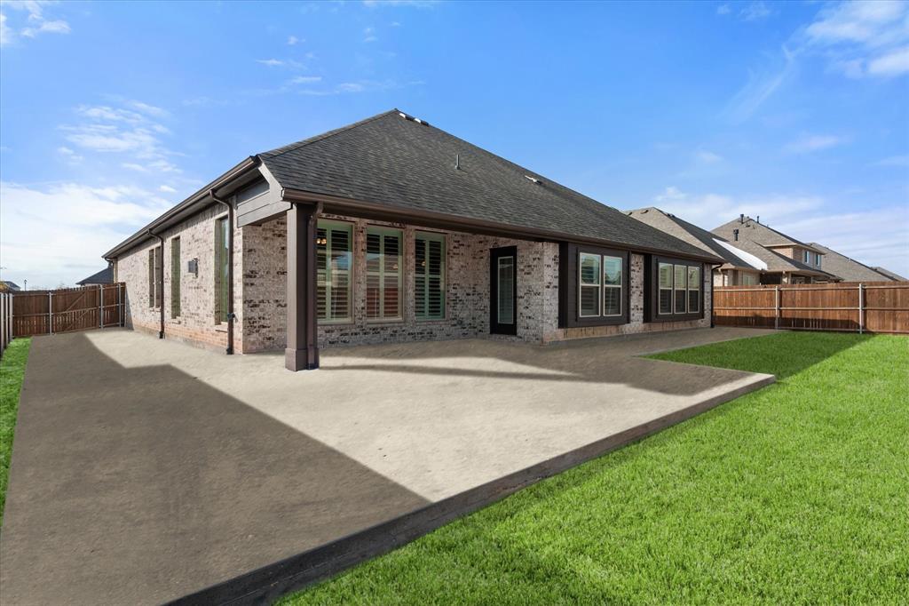 Come and see your next home! This move-in ready single-story four bedroom home offers a spacious open concept layout with plenty of windows and a beautiful kitchen opening up to a large living area. All eyes are drawn to the beautiful solid oak wood flooring that leads to the main focal point a stone fireplace and hearth. The kitchen offers ample cabinetry, built-in stainless steel appliances, a gas cooktop, and large pantry.
The thoughtful split-bedroom design includes a private primary suite plus three additional bedrooms, one with its own ensuite bath ideal for multi-generational living. The primary suite features dual vanities, an expansive walk-in closet, and direct access to the laundry room.
You’ll love the convenient mudroom. A spacious 2.5-car garage with a dedicated circuit for the included full sized garage fridge adds to everyday functionality. Refrigerators, washer, and dryer are all included. Enjoy a large covered patio and a generous backyard perfect for entertaining. Shutters and neutral finishes throughout this beautiful home makes it easy to imagine yourself calling this home.