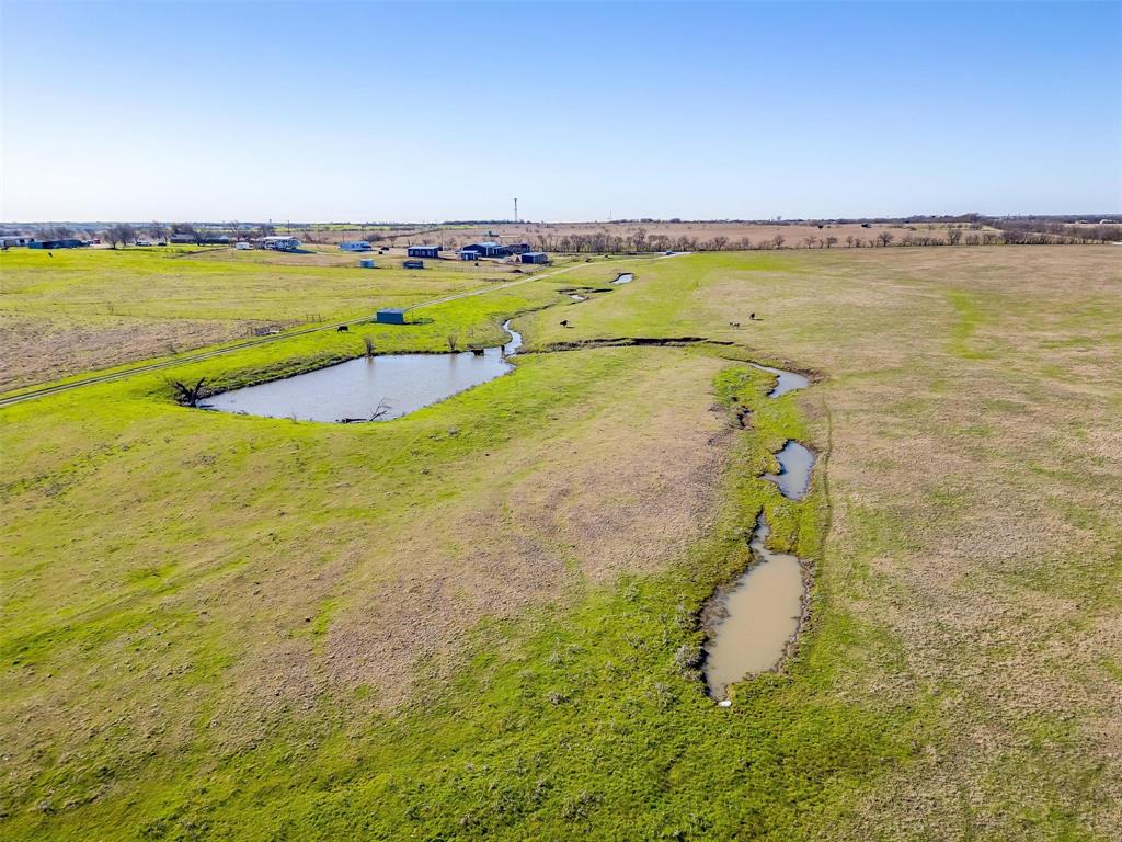 Just outside of the city limits of Ponder, this expansive 78 approx acreage features a versatile space that is ideal for residential development, investment or continue its current usage of a cattle pair operation. Offering roughly 2,291 feet of road frontage along T. N. Skiles, this property presents significant development potential within a rapidly growing area. Ponder is a vibrant community in Denton County that is only 14 miles west of Denton; and is witnessing substantial residential and commercial growth, including several new housing developments, new roads, and a wealth of upcoming opportunities. With very few large tracts of land available on the market, this property is a rare find and a must-see for anyone looking to invest in a promising future. Don't miss your chance to explore the possibilities that await on this remarkable property!