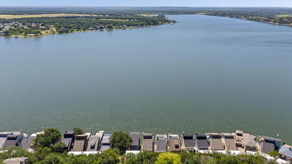 Experience the best of lakefront living in this beautifully appointed 2-bedroom, 2-bath waterfront retreat on the coveted main body of the lake. Whether you're searching for a full-time residence, a weekend escape, or a high-performing VRBO investment, this home offers the perfect blend of comfort, style, and unforgettable views.
Wake up to sparkling open-water vistas and spend your days boating, fishing, paddleboarding, or swimming right from your private boathouse. The open-concept floor plan is filled with natural light, while multiple lakeside decks create the ultimate setting for entertaining family and friends.
As the sun begins to set, pour your favorite cocktail, fire up the grill, and relax on the spacious deck while taking in breathtaking panoramic views. 
Perfectly positioned on the main body, this property offers year-round water access and an exceptional location that guests will love, making it an outstanding VRBO or Airbnb opportunity with excellent income potential.
This isn't just a lake house—it's where lifelong memories are made. Whether you're enjoying sunrise coffee, sunset cocktails, or weekends on the water, every day feels like a vacation.