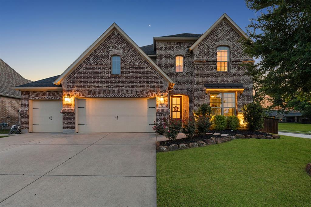 Welcome to this stunning modern home in the highly sought-after Trinity Falls community, nestled on a rare corner cul-de-sac lot adjacent to a lush greenbelt. From the moment you step inside, soaring 18-foot ceilings, spiral staircase, rich hardwood floors, and a dramatic floor-to-ceiling stone fireplace set the tone for the designer-curated upgrades found throughout. The open-concept layout seamlessly connects the living, dining, and kitchen spaces — ideal for entertaining. The chef's kitchen impresses with marble countertops, a glass tile backsplash, stainless steel appliances, and a 5-burner gas cooktop. The main floor also features a spacious primary suite with a luxurious en suite bath and walk in closet, plus a private guest bedroom downstairs with its own full bathroom. Upstairs, enjoy a game room, media room, and generously sized secondary bedrooms. Plantation shutters and motorized blinds add a polished finishing touch throughout. Full house water and filtration system and reverse osmosis drinking water in kitchen. Step outside and enter your own private oasis — a breathtaking backyard retreat designed for those who love to live and entertain outdoors. The resort-style pool stuns with elegant fire bowls and a cascading waterfall! Putting green, full outdoor kitchen, and covered patio with a cozy fire pit complete a backyard that truly has it all. Fresh landscaping and new luxury tile around the pool. Privacy fencing ensures the space feels like an exclusive escape, no matter the occasion. Don't overlook the extensive attic storage and the 3-car garage with upgraded epoxy flooring. As a Trinity Falls resident, you'll also enjoy community amenities including a beach-entry pool, splash pad, playgrounds, dog park, fitness center, and scenic hike and bike trails.