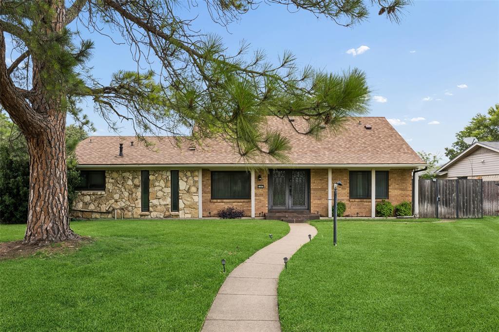 Exceptionally beautiful Mid-Century Modern home nestled in a highly desirable location, right in the heart of everything the city has to offer. Distinctive stone and brick architecture, double iron-gated entry doors, and designer details create impressive curb appeal. Inside, vaulted ceilings, a striking wood accent wall, marble fireplace, and open staircase with iron railings complement the home's timeless modern design. The open-concept living, dining, kitchen, and entry areas are both stylish and functional, creating an ideal space for everyday living and entertaining. The kitchen features granite countertops, stainless steel appliances, an induction cooktop, soft-close under-counter drawers, and updated PVC plumbing that replaced the original cast-iron lines in 2026. A Nest thermostat adds smart-home convenience. The thoughtfully designed floor plan offers two bedrooms and one updated bath downstairs, with two additional bedrooms and a second updated bath upstairs. Both bathrooms feature frameless glass and stand-up tile showers. Recent improvements include a new roof in 2023 and a tankless water heater installed in 2025. Designed for year-round enjoyment, the backyard is a private retreat featuring a sparkling swimming pool, covered patio, pergola, outdoor kitchen with built-in grill, extra burners, sink, and refrigerator, plus an outdoor cabana bath complete with shower, sink, and toilet. Perfect for hosting gatherings or relaxing outdoors, this space is made for enjoying Texas living. No HOA. Quick and easy access to major thoroughfares, shopping, dining, and entertainment options to enjoy.