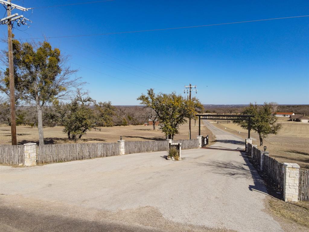 This 16.96 acre property is perfect for someone looking to move out to the country but have the privacy and security of a gated community. This property is a corner lot at the entrance of the community with lots of road frontage and loads of possibilities. The structure is already complete with a water well, septic tank and electricity. There's a small bunk room above the garage and a full bath downstairs, a covered patio to enjoy the quiet country evenings with family and friends. The owner is offering a Kubota RTV and zero turn mower with reasonable offers.