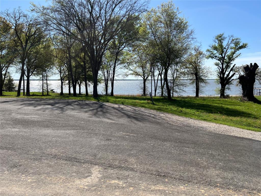 Gorgeous views! This is a .64 Acre lot with lake view, not a house. Cedar Creek Landing is an upscale gated community on Cedar Creek Lake with waterfront clubhouse with infinity edge pool, fitness center and entertaining space including grills next to the boat launch. Multi dock private marina for property owner day use or when friends visit by boat. Take a golf cart ride to the stocked community fishing pond or to adjacent Cedar Creek Country Club which offers 18 challenging holes of golf, tennis courts, restaurant and social events (memberships available). This over half acre lot located in a cul-de-sac within walking distance of the lakeside club house. Community also provides a locked fenced area for boat trailer storage. Off water homes restricted to site built homes 1,400 sq. ft. HVAC living space plus two car garage. All lots have city maintained paved roads, water, sewer & fiber optic internet. Located on the northern end of the lake making it less than an hour drive from Downtown.