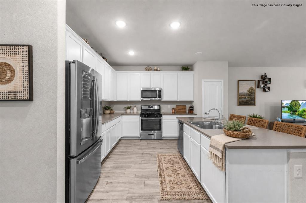 **MOVE IN READY. This stunning single-story home blends modern design with everyday comfort. Featuring 3 bedrooms and 2 bathrooms, this residence sits in a sought-after neighborhood within the Fort Worth Independent School District. Step inside to find a bright, open-concept layout with stylish wood-look flooring throughout the main living areas. The beautiful kitchen is the heart of the home, complete with large island with seating and ample cabinet space. Perfect for entertaining, the kitchen flows seamlessly into the dining and living areas. The private owner’s suite offers a peaceful retreat with an ensuite bathroom and walk-in closet, the other additional bedrooms provide flexibility for family, guests, or a home office. Outdoors, enjoy a spacious backyard with a covered patio, ideal for relaxing or hosting BBQs. The fenced yard provides plenty of room for kids, pets, or future landscaping projects. Additional highlights include a two-car garage, energy-efficient features, and a prime location with easy access to major highways, shopping, dining, and entertainment.