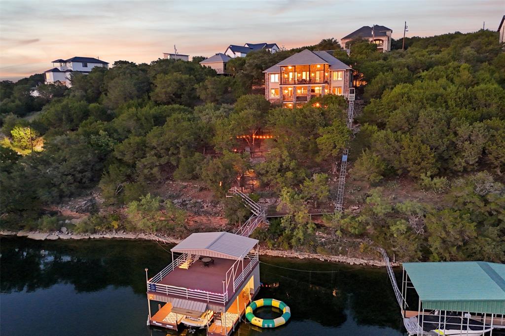 Water front location on 2 lots in The Cliffs, this incredible property offers an unparalleled retreat. There are 4 large bedrooms, each with ensuite bath. Recently renovated, the home features a meticulously redesigned kitchen with Taj Mahal counters that opens to the living & dining room, offering fantastic views of the water & landscape. The panoramic views from the dual decks stretch for miles, providing an ever-changing canvas of breathtaking sunsets over Neely's Slough. The downstairs game room is a delight with shuffle board, video games & wet bar. The attention to detail extends outdoors with a two story dock, boat & sea doo slips, plus electric cover for boat. To add a touch of convenience, a tram offers easy access to the boat dock from the house. This property goes beyond the ordinary, boasting a myriad of amenities- new slate roof, charcoal filtration, solar, gate community. The property is sold furnished & opportunity for watercraft purchases for turn key ease!