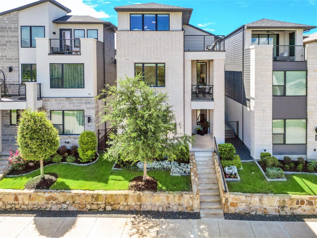Perfectly positioned along a scenic neighborhood greenbelt in the highly sought-after Craig Ranch community, 7629 Hewitt Drive offers a rare combination of luxury, flexibility, and lock-and-leave convenience. This exceptional three-level residence features the coveted Northampton floor plan, a private elevator serving all three levels, three car garage and a unique layout designed for effortless everyday living. Unlike many three-story homes, the primary living spaces are located on the second floor, where the great room, kitchen, dining area, owner's suite, and laundry room come together on one level. Elevated above the surrounding streetscape, the main living areas enjoy beautiful greenbelt views, abundant natural light, and enhanced privacy. The open-concept great room showcases soaring two-story ceilings and flows seamlessly into the chef's kitchen featuring quartz countertops, an oversized island, white cabinetry, KitchenAid gas cooktop, and stainless-steel appliances. The private owner's retreat offers dual walk-in closets and a spa-inspired bath. Designed with flexibility in mind, the first floor includes two secondary bedrooms, a full bath, a spacious gathering room, dry bar, and access to the extended patio and low-maintenance turfed yard. One bedroom has been thoughtfully converted into a private office with glass entry doors and greenbelt views. The third floor offers a spacious flex room, bedroom, full bath, and access to the rooftop terrace.
Additional highlights include three outdoor living spaces, an oversized tandem three-car garage with epoxy flooring, built-in storage systems, a mini-split HVAC system for year-round comfort, HOA-maintained front lawn care, and Frisco ISD schools. Just minutes from TPC Craig Ranch, shopping, dining, trails, and Highway 121, this home delivers an exceptional lifestyle in one of McKinney's most desirable communities.