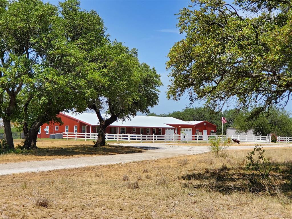 Folks! If you are looking for a nice home in the country with plenty of acres to roam, here is the one for you! This ranch is just outside the town of Brownwood, but offers plenty of quiet and seclusion. As you leave the paved FM road, you will take a paved driveway all the way up to home. This really nice property consists of a 2600 sf metal home (per CAD) with 3 bd 2 bth plus a nice sized office and large utility room. The living room and kitchen are of an open concept. Living area has a nice cozy, wood burning fireplace. Attached to the home is a nice, large 1290sf (per CAD) 2 car garage with workshop area. The home has a nice front porch, allowing you to relax and enjoy your evening. There is a 720 sf barn, 960sf shed, a 3 sided barn and cattle pens, and a few other outbuildings around the ranch. Besides county water to home, there are also 3 water wells with pumps, and 1 old windmill well. There is no earthen tank, but there is a large concrete tank, that holds water from well, and one can water in smaller troughs from it. The land itself, is very nice, having lots of brush and trees, being Live Oaks, Post Oaks, Cedar, Mesquite, and other brush and browse for the abundant wildlife. Wildlife consist of Deer, Dove, Hogs, Turkey, and other varmints. There are some open areas of grassland, allowing you to run a few head of livestock, if you choose. Ranch is in ag exemption for property taxes. Don't miss out on this Awesome gem of a ranch!