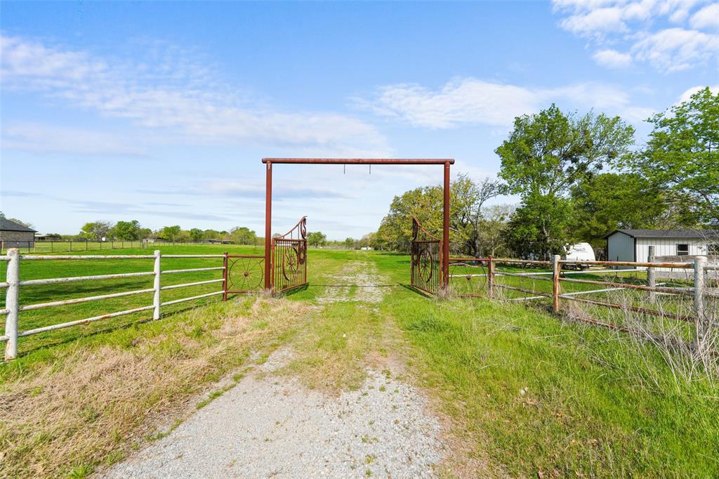 Enjoy the best of country living without sacrificing convenience this property sits just 10 minutes from I-30, making it easy to reach nearby shopping, dining, and everyday essentials. It’s an ideal setting for anyone wanting space, privacy, and a quiet escape to call their own.Built for both everyday enjoyment and entertaining, the property includes a basketball court and a spacious gazebo equipped with an outdoor kitchen perfect for hosting parties, family gatherings, or relaxing weekends at home.Horse enthusiasts will appreciate the on-site arena, offering a great space for riding and training. A peaceful creek borders the land, enhancing the natural beauty and creating a serene atmosphere. The property is fully fenced, with roughly 6–7 wooded acres situated within a floodplain.Optional opportunity: this property may be purchased with the neighboring 9.50-acre tract MLS #21236340.