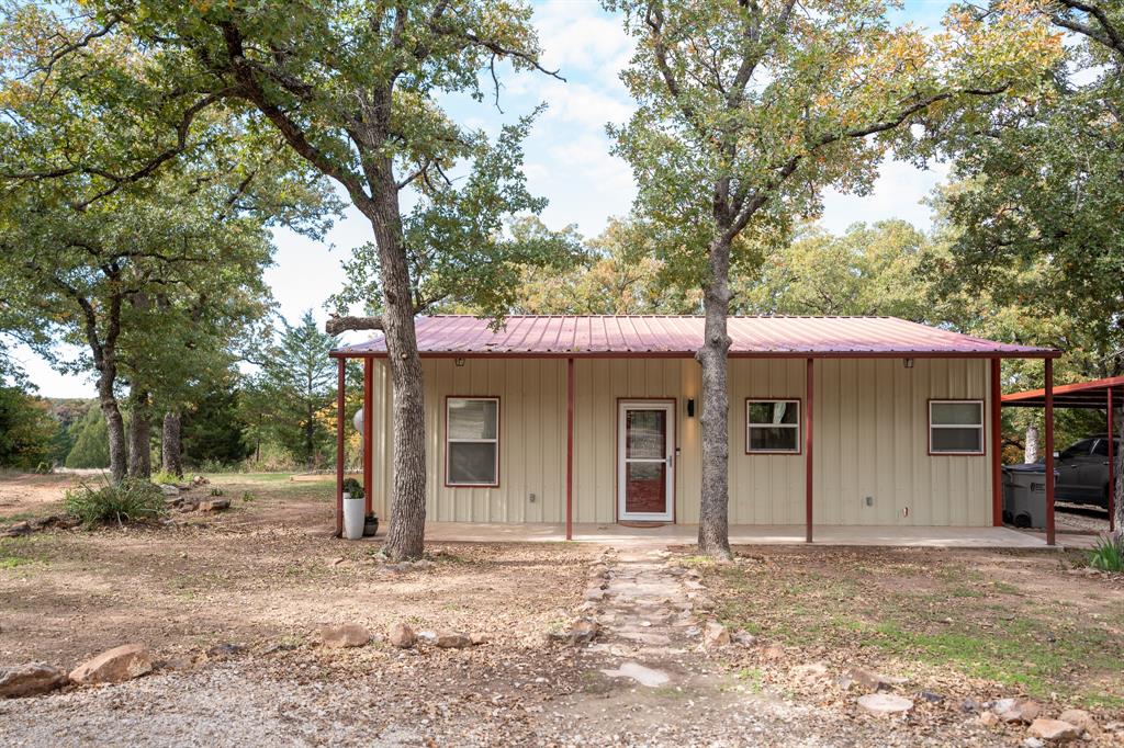 Looking for the perfect piece of Texas Country with a small pond and beautiful mature trees? Here it is!  Including a 30X40 BRAND NEW SHOP as this seller was transferred out of state, updated floors, kitchen oh my!  This 2015 Home was built with space in mind sitting atop of 8.8 acres open concept with tall ceilings and great storage inside and out! 2 Large bedrooms and oversized closets along with a dreamy kitchen await you in this Bowie Tx charmer!  The large covered back porch is the perfect location to star gaze on a summer night and make smores in the fire pit.   No dirt road and only 3 miles from city limits.  Outside you will find mature hardwoods and just enough land to feel privacy. Including several storage out buildings and carport!  The property features a new shooting range and new construction of 30x40 metal shop with 20x10 covered porch!  Acerage, dream house, pond, shop and recreational shooting equal what Texas dreams are made of!  RV hook up ready!