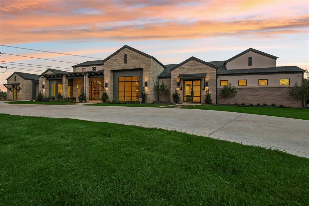 Back on the Market! Previous buyer decided to back out at no fault of the seller. 2024 Custom-built Lewis & Earley masterpiece with a 4 car garage nestled in the prestigious Hat Creek Estates Bartonville community! This luxurious Argyle ISD home showcases a sleek, contemporary design, expansive windows and premium finishes throughout. Ideal for both entertaining and everyday living, the living areas are seamlessly blended in one wing of the home with abundant natural light to create a bright, inviting atmosphere. The modern, glass enclosed executive office is a show stopper. Equipped with soft-close cabinets and drawers, elegant quartz and marble counters, designer lighting, and top-of-the-line Wolf-Sub Zero-Bosch appliances, the sophisticated kitchen is ideal for luxurious tastes. A secondary catering kitchen-laundry room, complete with ice maker, refrigerator and dishwasher adds convenience and functionality. The living area flows effortlessly to an outdoor climate controlled living space boasting automatic screens and surround sound. Set on a 2.53 acre cul de sac lot, this exceptional home is the pinnacle of modern living.