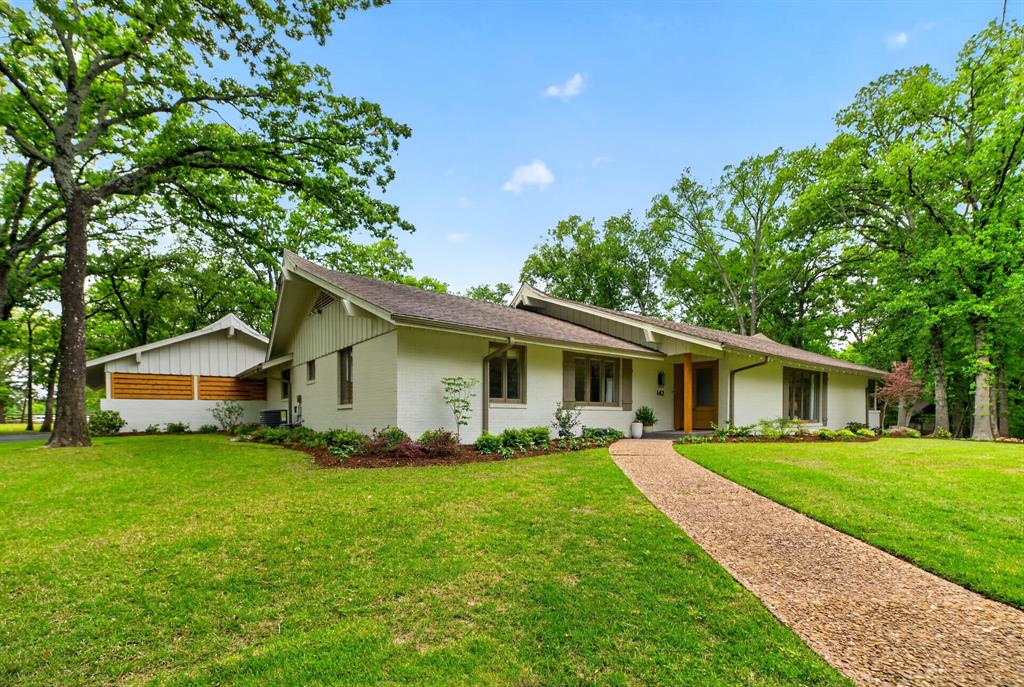 Fully renovated 4-bedroom, 3-bath ranch on Cedar Lane, privately nestled beneath mature post oaks on nearly 2 cleared and manicured acres. Thoughtfully redesigned, this home pairs timeless architectural character with elevated modern finishes throughout. The kitchen is anchored by an oversized island with marble countertops, custom cabinetry, and premium Fisher & Paykel appliances. Sawyer Mason engineered hardwood floors flow throughout the home, while the main living room features a vaulted ceiling with exposed beam detail. The primary suite features a spacious shower with Kohler fixtures and a double vanity with Taj Mahal quartzite. One guest bath features a deep soaking tub with marble tile, while handmade Moroccan zellige tile adds a distinctive finish in the secondary baths. A stone patio extends from the main living areas and is surrounded by mature landscaping and a peaceful natural setting. A rare offering where timeless character, elevated finishes, and a remarkable setting come together. Agent is also homeowner.