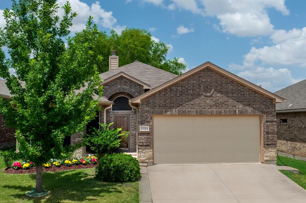 This beautiful one-story open floor plan home located in Northwest ISD shows true care from home ownership.  It is Move-in ready with carpet in bedrooms and living room, easy maintenance tile floors in bathrooms and kitchen,  quartz countertops with new faucets and shutoffs in bathrooms and kitchen.  Great living room features a beautiful fireplace and 14 foot vaulted ceiling with open living concept.  The main bedroom is very spacious with walk-in closet, dual sinks, and separate tub and shower.  The back patio has shade and great for outdoor grilling.  The exterior has new gutters with covers installed in 2025.  The back fence was stained in 2025 and Irrigation system master valve and double check valve replaced June 2026.  The home features solar screens and storm doors for better insulation.  Roof was installed in 2022. Refrigerator and washer and dryer convey.