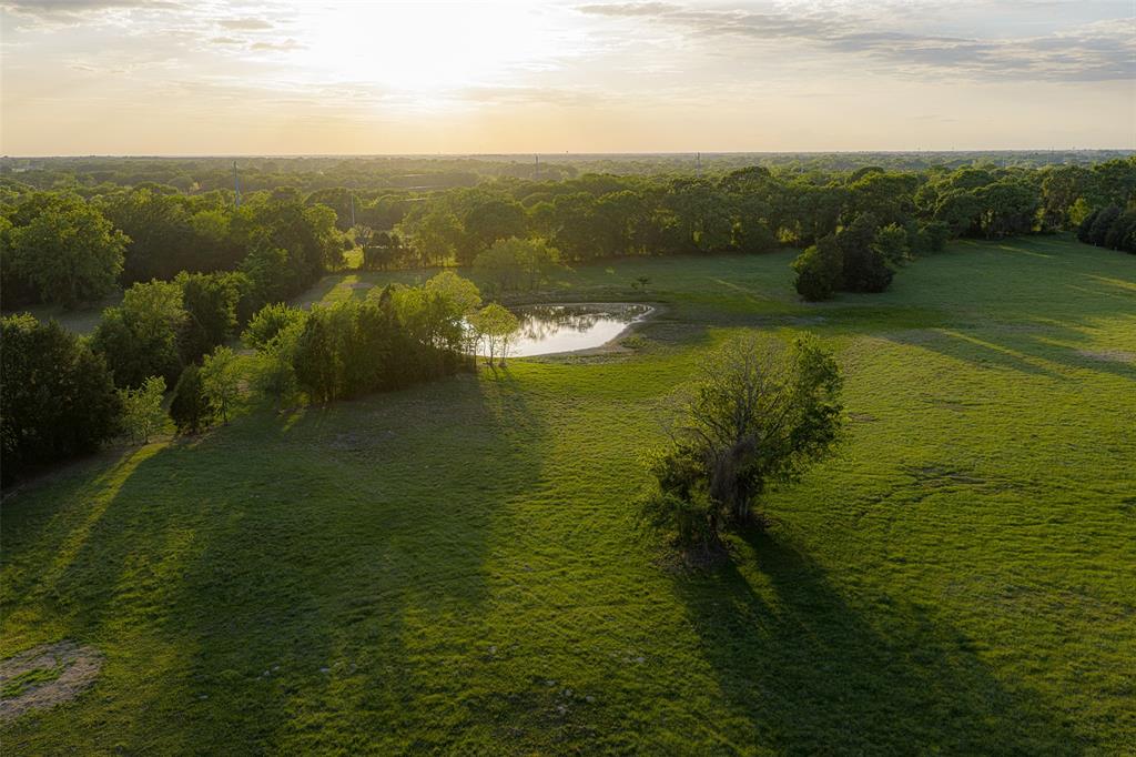 Located within an easy hour and a half drive of Dallas, this versatile 48-acre property offers an exceptional opportunity for multi-family living, agricultural use, or future investment potential. With convenient access via Highway 175, the property combines functionality, flexibility, and rural charm in a highly accessible location.
The property features two residences, making it ideal for extended family, rental income, or a primary residence with a guest home. The original home offers approximately 1,750 square feet with a comfortable 3-bedroom, 2.5-bath floor plan. Complementing it is a newer, custom-built barndominium totaling approximately 3,300 square feet, with around 2,350 square feet of beautifully finished living space. This thoughtfully designed home features high-end finishes, an open-concept layout, 4 bedrooms, 3 bathrooms, and a large covered back porch perfect for enjoying the surrounding countryside.
Designed with agricultural functionality in mind, the acreage is cross-fenced and well-equipped for livestock. Multiple stock tanks, along with additional concrete water troughs featuring auto-level systems, provide reliable, year-round water sources. The land is well-suited for cattle, horses, or a hobby farm operation.
Additional improvements include a large enclosed shop, ideal for equipment, tools, and general storage needs. The layout of the property, combined with its highway frontage, offers the unique advantage of being able to separate the residential improvements from the remaining acreage—creating opportunities for multiple uses, whether agricultural, recreational, or potential future development.
This is a rare chance to own a well-improved, highly usable tract in a desirable location with easy access to Dallas and surrounding communities.  Call today to setup your own private showing.