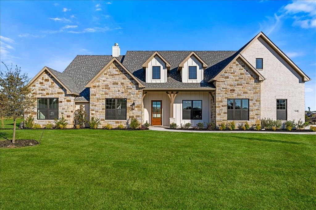 MLS# 21151390 - Built by Doug Parr Homes - Ready Now! ~ Set on a full one-acre lot in Stardust Ranch, this traditional-style home blends timeless design with thoughtful, high-end details. The layout offers five bedrooms, including a large upstairs bonus bedroom, an extended game room, and an additional flex space, providing room to grow, work, and entertain.  The heart of the home features a vaulted living area with exposed beams and a gas fireplace, opening seamlessly to a vaulted covered patio through full glass sliding doors—ideal for indoor-outdoor living. A wood-inlaid box ceiling highlights the breakfast nook, while box ceilings continue throughout the primary suite, dining room, and foyer, adding architectural depth throughout the home.  The kitchen is designed to impress with a large island, café-style professional appliances, gas cooktop, and an oversized walk-in pantry complete with a dedicated coffee bar.  The primary suite is a true retreat, featuring a double box ceiling and double doors leading into a spa-inspired ensuite. The bath includes a luxury soaking tub, extra-long dual-sink vanity, and a spacious dual-head walk-in shower. An oversized walk-in closet with built-in shelving connects directly to the utility room, which includes built-in cabinets and shelving for added convenience.  Additional highlights include a built-in mudroom bench, tankless water heater, and a four-car garage configuration with a three-car garage plus an attached bolt-on garage, ideal for storage, hobbies, or extra vehicles.  Located in Northwest ISD and zoned for Lance Thompson Elementary, Pike Middle School, and Northwest High School. Stardust Ranch offers a peaceful, non-gated setting with open space and a strong sense of community.