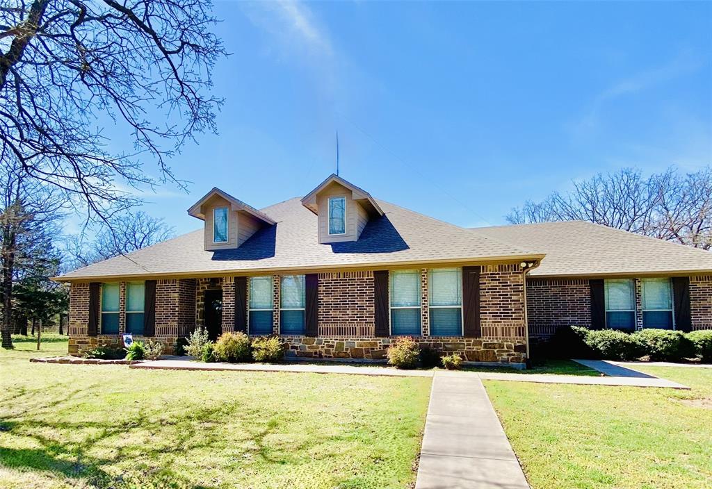 **PRICE IMPROVEMENT!** Looking to leave city life behind and embrace the simple luxury of country living?  This solidly built, spacious home sits on over 6 serene, wooded acres just outside the charming, small-town community of Bowie, Texas.  Features include 3+ bedrooms, 2 full baths, and a large bonus room that can be used as either additional living space, or a large 4th bedroom - bunkroom.  The spacious primary suite offers an ensuite with garden tub, seperate shower, and walk-in closet. The eat-in kitchen boasts granite countertops, stainless steel appliances, a beautiful stonework island-bar, and a spacious pantry.  Enjoy relaxing with family and friends on the covered patio overlooking your wooded backyard and acreage beyond.  This private country haven also features a large garage - workshop with electricity and concrete floor, and includes an unfinished room that, with your touch, has potential for a guestroom or craft space. Property is fenced, cross-fenced, and gated for your privacy.  **Most furnishings, refrigerator, washer, dryer, and pit boss smoker on back patio may be negotiable with accepted offer.