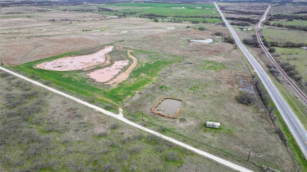 46 Acres AG EXEMPT land with over 2800 feet of HIGHWAY FRONTAGE!!!  WATER IS FOUND IN ABUNDANCE HERE!  Approximately 40 acres sprigged in coastal and approximately 6 acres planted with wheat. 2 Tanks for watering as well as TWO HIGH PRODUCTION WATER WELLS WITH CAPABILITY of producing 100 gallons per minute and electricity on property.  Seller has maintained agricultural exemption with cattle.  Property has shed for storage.  Opportunities are endless here as subdividing would allow for multi family residences and or manufactured home park or keep it in ag use with the perfect set up!