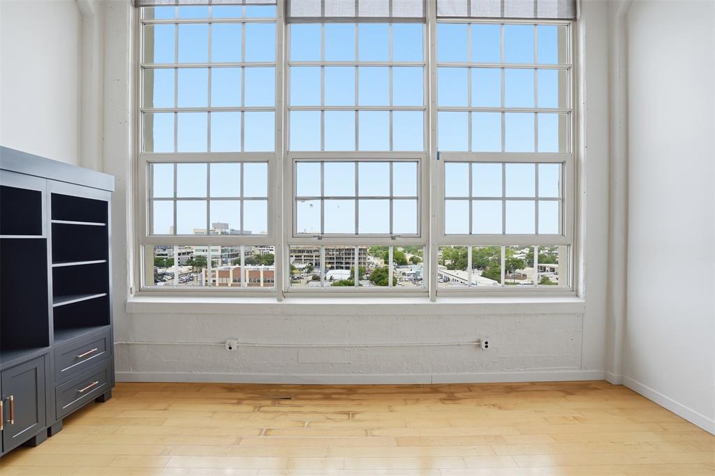 Make this condo your own! Montgomery Plaza #1727 is an exceptional 2 bedroom, 2 bathroom residence that offers the ultimate lock-and-leave lifestyle in one of Fort Worth’s most iconic buildings in the most walkable neighborhood. Located on the 7th floor, this condo showcases breathtaking, unobstructed views of the Cultural District through dramatic 16-foot floor-to-ceiling windows that flood the space with natural light.

Originally a historic landmark, Montgomery Plaza was thoughtfully transformed into luxury condominiums featuring resort-style amenities, premier retail, dining, and everyday conveniences all within the building and surrounding pockets on W7th. Residents enjoy a vibrant urban lifestyle just minutes from Downtown Fort Worth, Sundance Square, The Stockyards, the Museum District and Near Southside.

Inside, sophisticated finishes create a timeless yet contemporary aesthetic. Engineered hardwood flooring, museum-smooth walls, transom windows, dark-stained cabinetry, and industrial-inspired architectural details complement the soaring ceilings and expansive open-concept design.

Beyond the residence itself, residents have access to an impressive collection of amenities including a resort-style pool with private cabanas, outdoor cooking and entertaining areas, a fully equipped fitness center, movie theater, and an inviting third-floor owner’s lounge designed for gathering and relaxation.

The property also includes two side-by-side DEEDED parking spaces in the attached garage. Pricing has been adjusted to reflect the estimated repair of the living room wood flooring, presenting an outstanding opportunity to own in one of Fort Worth’s most desirable urban communities. Seller is providing a $10,000 flooring allowance.