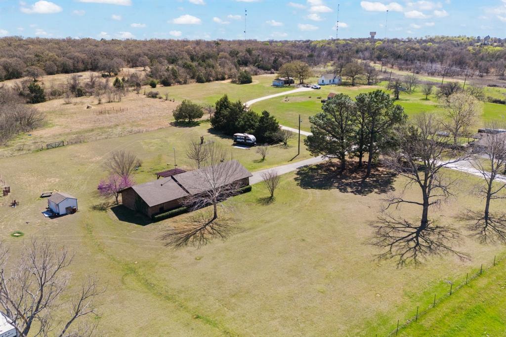 Discover the perfect blend of country living and modern comfort on this stunning 62-acre ranch. This property features a 3-bedroom, 2-bathroom home with a spacious kitchen that seamlessly opens to a cozy breakfast room. The formal dining room is open to living area that has an electric stove, raised ceiling with exposed beams and this layout is ideal for both everyday living and entertaining. Great size bedrooms down the hall with storage space. Primary bedroom has walk in closet and ensuite bath with shower. Large vanity in second bathroom. Step outside to enjoy the pergola-covered back patio, perfect for relaxing and taking in the peaceful surroundings. The land itself is a dream, offering a mix of open pasture, mature trees, and a pond, ideal for livestock, horses, or recreation. Cross-fencing is already in place, providing easy management of animals. Hunters dream, dear, turkey and more on the property. The front has costal pastures used to cut hay.