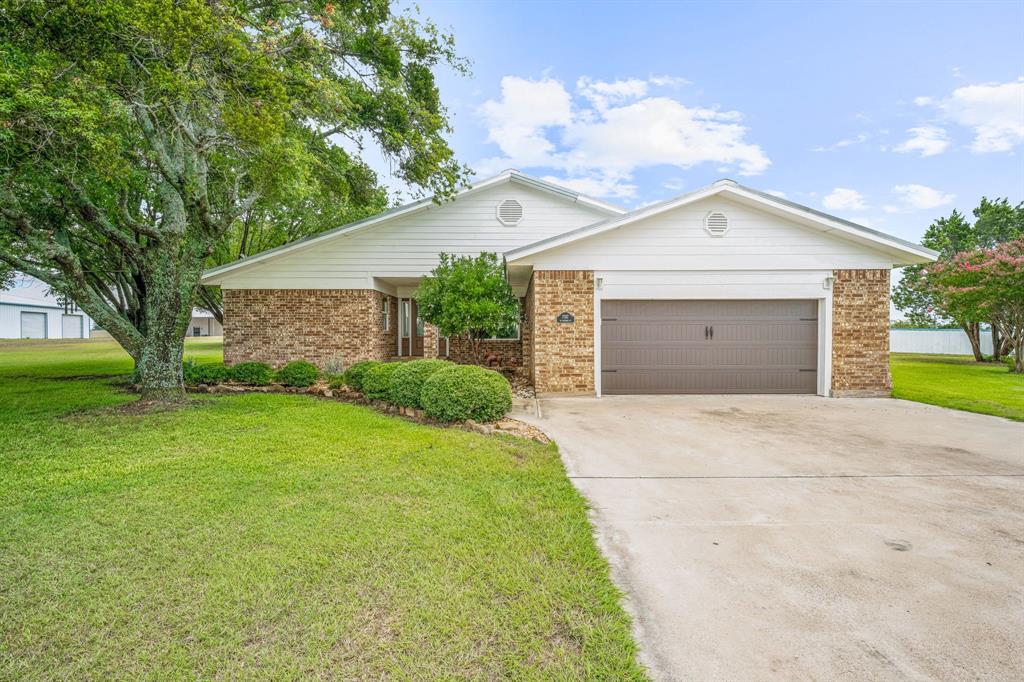 MULTI-USE PROPERTY! This expansive 4.35 acre multi-use property located on US Highway 67 offers a multitude of possibilities for a new owner. Featuring a 2100 sq ft brick house with 3 bedrooms and 2 baths, a spacious open concept design, KitchenAid appliances, and a large master suite with a walk-in shower. The backyard has iron fencing, and a large, rock patio. The property also includes a 4600 sq ft metal building with six 10'-14' roll up doors and 50 amp electricity, a 3300 sq ft metal building with two 12' roll up doors and a second story for storage, and an 800 sq ft modular home with a metal covering for parking. With a commercial entrance and a residential entrance, this property is perfect for a variety of businesses or homesteads looking for a prime location with plenty of space and amenities. Seller would consider selling house with one acre, and without the shops.