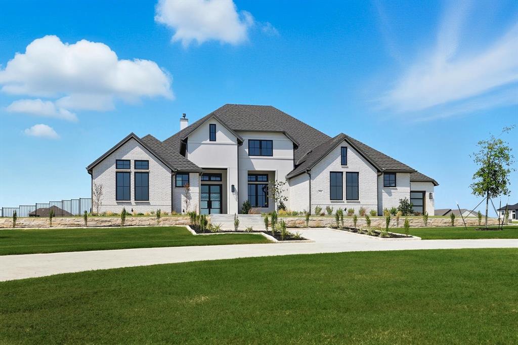 Thoughtfully designed transitional on acre lot in gated Harper Estates! 12 foot ceilings in main living areas, Andersen Series windows provide natural light throughout! Seamless indoor-outdoor flow with large Western sliders in both living areas open to outdoor living area with FP, full built in kitchen! Stunning White oak nail down hardwood floors in all living areas plus primary suite. Prewired for potential wine room in dining for climate control! Dream kitchen opens to main living with custom designed cabinets, abundant storage, equipped with GE Monogram series SS 6 burner gas cooktop, 48 in built in Fridge double ovens, custom vent hood. Fully equipped prep kitchen has second dishwasher, sink so main kitchen to stays polished ready for entertaining! Private beverage center with under counter fridge drawers just inside entry to Primary Suite. Spa inspired Ensuite bath has beautiful custom cabinets, dual separate vanities, large walk in shower with frameless glass, floor to seeing polished Venato Gold marble.  Free standing solid surface tub, large walk in closet! 4 additional Ensuite BRs with large walk in closets offer flexibility for family needs and privacy!  Second living area with attached media room has wet bar with another fridge, ice maker! Large laundry with sink, cabinets extra storage also has built in space for hampers or dog kennel! 4 car garage has full foam encapsulation, is fully conditioned with HVAC and heat, epoxy flooring, 2 exterior doors, Electric vehicle charger, Steel and glass doors, Jackshaft side openers allowing ceilings to remain free from opener equipment! Entire home is full foam encapsulated for energy efficiency. This true custom home has excellent craftsmanship, loaded with beautiful design upgrades throughout! Fully sodded lot has irrigation, aerobic systems staged for possible future pool build. Pool designs available if desired. Circular drive and additional driveway provide extra parking for guests!