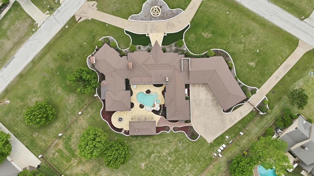 Experience exceptional privacy, engineering, and resort-style living in this remarkable gated estate on two acres. Constructed with insulated concrete form (ICF) walls, this home offers superior durability, energy efficiency, and peace of mind. Designed for both entertaining and everyday comfort, the open-concept layout features a grand living area with a statement fireplace flowing seamlessly into the dining space and gourmet kitchen. The chef’s kitchen is equipped with a large island, custom cabinetry, double ovens, and a prep sink.  A state-of-the-art geothermal system, spray foam insulation, fresh air exchange, and zoned HVAC provide outstanding efficiency, while a whole-home smart system and 125 kW backup generator ensure convenience and reliability. The private primary suite offers backyard access and a spa-inspired bath with garden tub, dual vanities, heated floors, and a custom walk-in closet. Secondary bedrooms are thoughtfully separated for privacy.  Designed for elevated living, the home includes a dedicated theatre or media room with projector and surround sound, along with integrated audio-visual systems throughout and multiple fireplaces with custom stonework.  Outdoors, enjoy a resort-style pool and spa with a dramatic cascading stone waterfall, expansive covered patio, outdoor kitchen, exterior TV, and automated screened enclosures. A well-appointed pool house with bath adds versatility, while an oversized fire pit creates the perfect gathering space.  The grounds feature professional landscaping, extensive stonework, advanced drainage and irrigation, and multiple driveways including a circular approach leading to a six-car garage and motor court. A custom automated gate, private well, dual septic systems, reverse osmosis filtration, and premium windows further enhance this extraordinary property.  This is a rare opportunity to own a meticulously engineered luxury estate blending innovation, comfort, and timeless design!