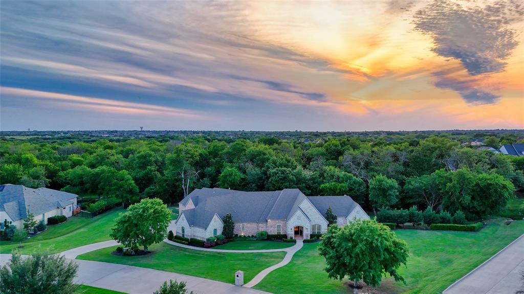 Established within Prosper’s exclusive gated community of Christie Farms, this beautiful custom one-story Dave R. Williams remodeled residence offers luxury living on an expansive 2ac, tree-lined creek lot. Spanning 4,532sf, this estate features 5 spacious bedrooms, 5.1 baths, an ensuite for each room, and a floor plan designed for modern and functional living. Step inside onto new natural white oak hardwoods, with a striking herringbone pattern greeting you at the entry. An updated and dedicated home office at the front of the home allows for work from home. The dining room features designer wallpaper and light fixtures, with windows framing the pool-ready backyard. The gourmet kitchen, fully remodeled in 2021, with no detail overlooked, showcases natural white oak cabinetry wrapped in honed marble, designer lighting, Wolf & Sub-Zero, tower wine fridge, and a walk-in pantry with a hidden storm shelter. The expanded breakfast nook, now features large black framed windows, and room for the whole family. The living room boasts vaulted ceilings with architectural beams and a modern gas fireplace wrapped in shiplap create a warm and inviting atmosphere, perfect for hosting large gatherings.  The primary is situated in a private wing for ultimate privacy, with a guest suite at the front of the home, and three secondary bedrooms extending towards the rear, providing comfort for all. A versatile game and media room add to the home’s entertainment appeal, while seamless indoor-outdoor flow makes this residence an entertainer’s dream. Newly planted landscaping sets the stage for you to dream big for a custom-designed pool and outdoor upgrades. Texas Basement and Whole Home Water Filtration and Softener. This rare gem combines refined luxury, functional design, and stunning natural surroundings. PISD, Cockrell Elementary, Rogers Middle School, and the nationally recognized, Walnut Grove HS. Opportunities like this are rare and won't last!