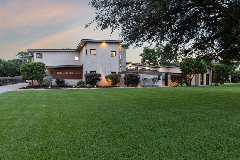 Escape to this luxury modern retreat with striking architectural design, incorporating sleek styling & abundant natural light. You're greeted by an open floor plan with stunning views of the large backyard & pool. The layout seamlessly integrates the living, bar, dining, & kitchen areas, creating an ideal space for relaxation & entertaining. Chef's kitchen features upscale appliances, sleek cabinetry, large island, walk-in pantry & butler's pantry. First floor has theater, gym & a bonus room that can be used as an office or lounge. The primary bedroom is a sanctuary with fireplace, sitting area & coffee bar. The en-suite bathroom is spa-like with dual shower, free-standing tub, & spacious custom closet spaces. Second floor features 4 oversized bedrooms, a game room, a laundry room, and two AC’d storage rooms. Entertain effortlessly on the patio with a built-in grill, mini-fridge & fireplace. This is a unique gem of a home that offers the perfect blend of comfort, style & convenience.