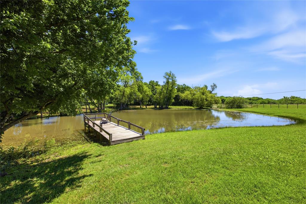 **$80,000 PRICE REDUCTION — NOW PRICED BELOW APPRAISAL!** Rarely does a private waterfront property with acreage, major system updates, and exceptional value become available at this price point.

Nestled behind a gated entrance on 2.6 scenic acres, this move-in ready country retreat offers the perfect combination of privacy, space, and modern comfort. A stocked pond with a private fishing pier creates a true backyard oasis, delivering peaceful water views, wildlife, and the serene lifestyle buyers dream of when searching for acreage properties.

Whether you're enjoying your morning coffee by the water, fishing from your own dock, or relaxing as you watch spectacular sunsets, this property offers the ultimate private escape just minutes from everyday conveniences.

Inside, the flexible floor plan features 3 spacious bedrooms plus a dedicated home office, flex room, or hobby space. Multiple living and dining areas, including a media room, provide endless possibilities for entertaining, multigenerational living, remote work, or simply spreading out and enjoying the home's generous layout.

The well-appointed kitchen features a gas range and ample workspace for cooking and gathering. Engineered wood flooring, new carpet, and abundant natural light create a warm, inviting atmosphere throughout.

The major updates have already been completed, including a NEW ROOF (2025) and NEW HVAC SYSTEM (2025), offering peace of mind and reducing future maintenance expenses. A storage building provides additional space for tools, equipment, outdoor gear, or workshop needs.

Properties offering **gated entry, acreage, a stocked pond, a private fishing dock, a media room, a home office, updated mechanical systems, and below-appraisal pricing** are increasingly difficult to find. If you're searching for a waterfront property, country estate, recreational property, or private retreat with room to breathe, this exceptional home delivers unmatched value and lifestyle.
