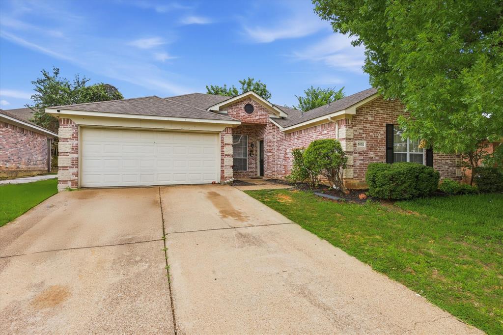 Welcome home to this charming 3-bedroom, 2-bathroom home with no HOA and inviting curb appeal that begins with a welcoming walk-up and front entry. Inside, you'll find tall ceilings and stained concrete floors that flow throughout the open-concept living, dining, and kitchen areas, creating a spacious setting ideal for everyday living and entertaining. Abundant natural light pours in through the many windows, offering beautiful views of the private backyard. The living room is anchored by a cozy fireplace with brick accents, adding warmth and character to the heart of the home. Tucked away from the secondary bedrooms, the primary suite provides a peaceful retreat and features an ensuite bath with a separate shower, deep soaking tub, and walk-in closet. Outside, the private backyard offers plenty of room to play, relax, garden, or host gatherings with family and friends.