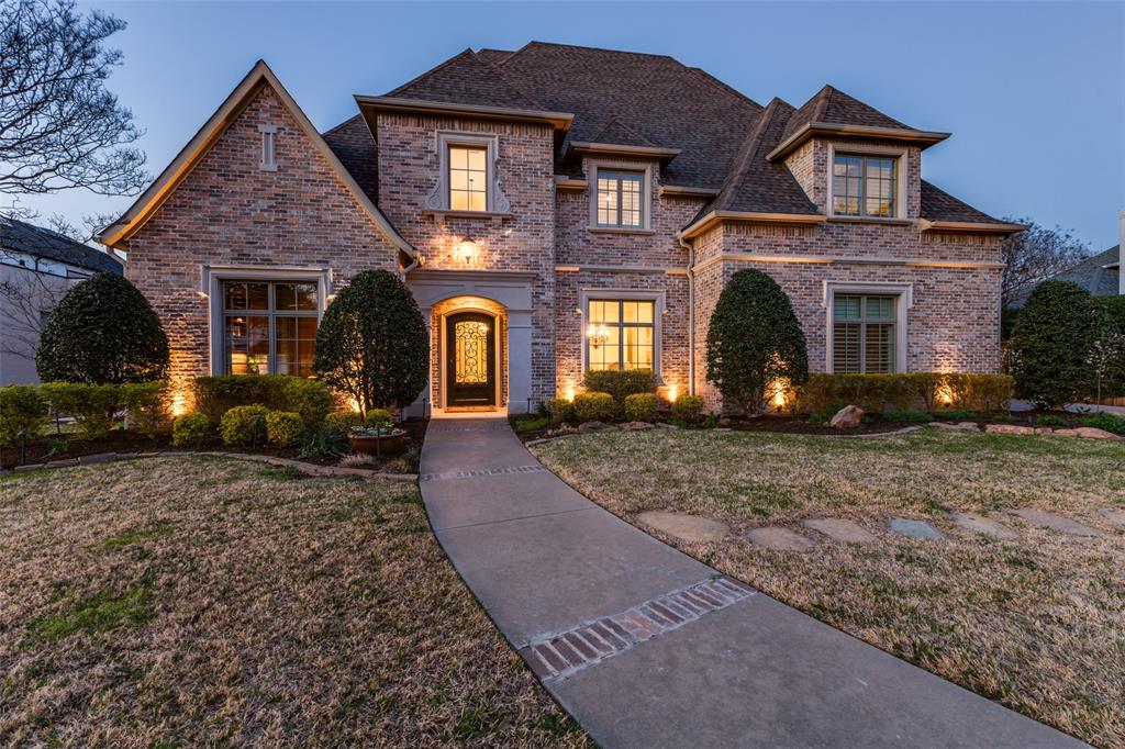 Set along one of Preston Royal’s most beautiful streets, known for its seasonal canopy of blooming azaleas, this elegant Preston Hollow traditional pairs timeless architecture with expansive living spaces. Walls of windows, rich hardwood floors, and detailed millwork create a refined yet welcoming atmosphere throughout the home. The main living room centers around a fireplace with custom built-ins and overlooks the backyard through expansive windows framing the pool and outdoor living areas. The oversized chef’s kitchen serves as the heart of the home, featuring granite countertops, a large island, abundant cabinetry, and a walk-in pantry, along with premium appliances including a Wolf oven and built-in Sub-Zero refrigerator. The kitchen opens to the breakfast and family living areas, creating an inviting gathering space for daily living and entertaining. A formal dining room offers an elegant setting for hosting, while a private study with custom wood built-ins provides a quiet workspace. The first-floor primary suite offers a spacious retreat with backyard views, a large walk-in closet system, and a bath with soaking tub, separate shower, and dual vanities. An additional bedroom with a private bath on the main level provides ideal accommodations for guests. Upstairs, multiple ensuite bedrooms are accompanied by a generous game room and media lounge with built-ins, a wet bar, and media wiring—ideal for movie nights, game days, and relaxed living. Set on nearly half an acre, the backyard offers resort-style amenities and usable green space. A covered outdoor living area with fireplace and built-in grill overlooks the pool and spa, while a grassy lawn provides room for recreation or pets. Mature landscaping enhances privacy and creates a serene setting. Ideally located in Preston Hollow near Preston Royal, Preston Center, and NorthPark Center, with convenient access to parks, private schools, medical centers, the Dallas North Tollway and Central Expressway.