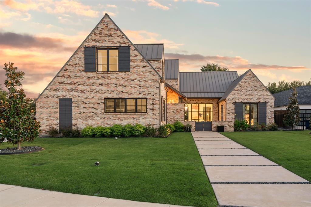 Some homes just feel different the moment you step inside, where every detail is intentional. Built in 2023 and set in the heart of Southlake, this home pairs architectural precision with warmth and livability. The kitchen is a centerpiece, blending function and design with a waterfall-edge marble island, custom cabinetry, and an oversized pantry.The open-concept living areas are defined by vaulted ceilings with wood beams and walls of windows that fill the home with natural light and create a seamless connection to the outdoors. The covered patio extends the living space with an outdoor kitchen, fireplace, and seating areas overlooking a pool and spa surrounded by turf for easy maintenance and year-round fun.Inside, a dedicated entertainment room with expansive windows offers a bright, inviting space for movie nights or casual gatherings. The moody downstairs office adds a touch of sophistication with built-ins and rich finishes that make it as functional as it is beautiful. 
The primary suite is tucked away for privacy and features views of the backyard, while a first-floor guest suite provides convenience for visitors.
Upstairs, three ensuite bedrooms are complemented by an additional TV or lounge area, offering flexibility for families or guests. Throughout the home, layered textures, exposed bricks, neutral tones, and thoughtful details create a cohesive and calming atmosphere.Located in Southlake with open enrollment to Carroll ISD, this home blends modern design, comfort, and location into something truly special.