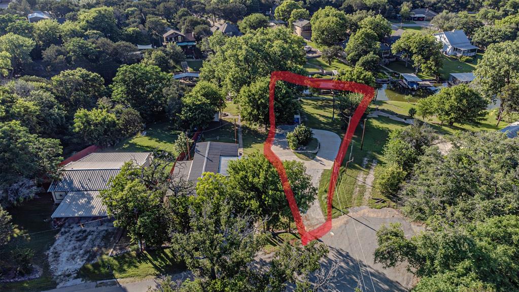 Check out this amazing lot on waterfront to build your dream home on famous Lake Granbury!! Tri level lot, palm trees, views that will knock your socks off! Bell tower cove with AMAZING VIEWS and about 30 seconds by boat to main body!! Boat dock needs some work, there is a carport, and tough shed. Site and soil was already done, and I just confirmed that they are still valid per Hood county environmental. Outside the City Limits, you needs permits for ONLY Septic. Build your dream Lake house, in one of the best neighborhoods in Hood County. No mobile homes allowed, but Stick built, & Barndo's are allowed. Call today to schedule your appt to view hit gorgeous lot.