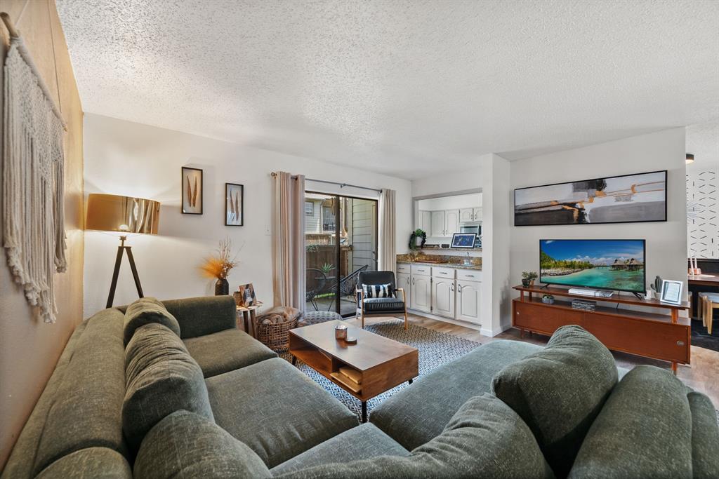 Welcome to this beautifully updated first-floor end-unit condo, ideally situated within a gated community in a prime location close to the Tollway, shops and dining. Offering two bedrooms and two full bathrooms, this thoughtfully designed home combines comfort, convenience, and low-maintenance living.

The inviting living room features an electric fireplace, a built-in wet bar, and sliding glass doors that open to a private covered patio—perfect for relaxing or entertaining. The kitchen overlooks both the dining and living areas and features granite countertops, bar seating, and a pantry.

The oversized primary suite offers a peaceful retreat with two walk in closets and an en suite bath featuring a dedicated vanity. A generously sized laundry room provides additional storage, adding to the home's everyday functionality. The second bedroom has a full bathroom and large closet space.

The property includes two assigned parking spaces, including one covered carport, along with convenient guest parking located directly in front of the unit.

HOA dues include water, sewer, and trash service, as well as access to community amenities including a swimming pool, clubhouse, and tennis courts. Whether you're a first-time homebuyer, downsizing, or looking for a lock-and-leave lifestyle, this move-in-ready condo is an exceptional opportunity.