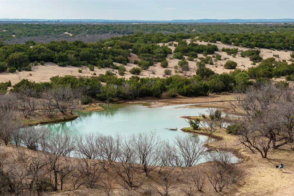 Discover this unique 285 acre ranch in Runnels County near Miles, Texas. This exceptional property offers a luxurious 3,800 square foot custom bardominium with 4 bedrooms and 4 bathrooms, an office and media room. The home features a chef's kitchen designed for gourmet cooking and effortless entertaining. An attached 2,400 square foot insulated shop provides ample space for vehicles, equipment, and hobbies.
Additionally, the diverse 285 acres deliver stunning views and a spring-fed lake stocked with trophy largemouth bass. Excellent roads cross the entire property for easy access. This dual-purpose land supports cattle grazing while providing prime hunting for whitetail deer, turkey, dove, and wild hogs.
Moreover, the ranch combines comfortable living with recreational opportunities. Buyers enjoy privacy, natural beauty, and strong potential for agriculture or leisure. Experience West Texas ranch life at its finest. Schedule a private tour today through Ekdahl Real Estate and seize this rare opportunity near Miles!