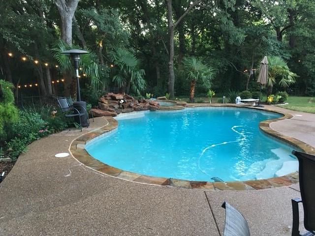 4 BR retreat on Private peninsula with your own private forest and creek-side boardwalk, 6 minutes from DFW Airport! 4 full
 baths for kids or multi-generational living. Spacious primary BR has pool-side view and access. The ensuite bath boasts
 custom frameless glass and granite. 3 bedrooms up with two full updated baths. The kitchen features a gas stove top, granite
 counters, an island and eat-in nook. The office is appointed in hard wood flooring and built-ins. Living room features hearth
 to ceiling Austin stone fireplace with gas starter and built-in cabinetry. Vaulted ceilings throughout downstairs gives a grand feel. Heated pool with water fall and spa. A well-equipped Cabana makes outdoor entertainment and
 living a breeze. It includes stone counter tops, a high-end grill, a 55 inch flatscreen, ice maker, sink
 and refrigerator. Even has a cozy, over-head heater for year-round comfort. Low voltage overhead
 and boardwalk lighting make a magical path to your park-like fire pit site. Try to find all of these
 amenities combined with this location for under $1M.