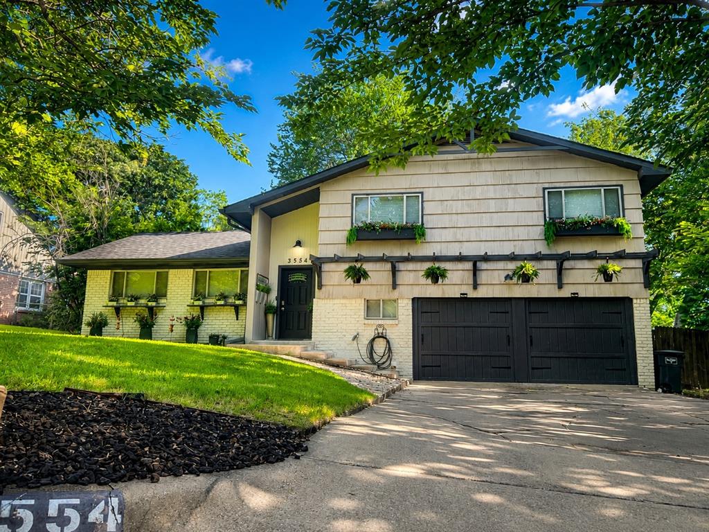 Discover the charm and versatility of this beautifully designed split-level home, offering a spacious layout perfect for any lifestyle. This home features four bedrooms and three full bathrooms, providing ample space for family, guests, or a dedicated home office.  The top floor showcases three generously sized bedrooms with stunning original hardwood floors, complemented by two fully updated bathrooms. On the main level, you’ll find a welcoming living area filled with natural light and stylish wood laminate flooring. The kitchen is a true centerpiece, boasting modern cabinetry, sleek granite countertops, a striking stone backsplash, and stainless steel appliances—perfect for creating home-cooked masterpieces. The lower level offers even more flexibility with an additional bedroom, a full bathroom, and a laundry room, making it ideal for a guest suite, in-law space, or private retreat. The 4th bedroom (Primary) is a Garage Conversion. Step outside to a spacious backyard oasis where mature trees provide ample shade over a large deck, creating a peaceful setting for relaxation or entertaining. Additionally, the property includes a fully equipped shop with electrical and water connections—ideal for a home office, workshop, or flex space. Conveniently located near major highways, the scenic Trinity Trail system, and endless shopping and dining options, this home offers the perfect balance of comfort, convenience, and functionality. Don’t miss this incredible opportunity—schedule your showing today!