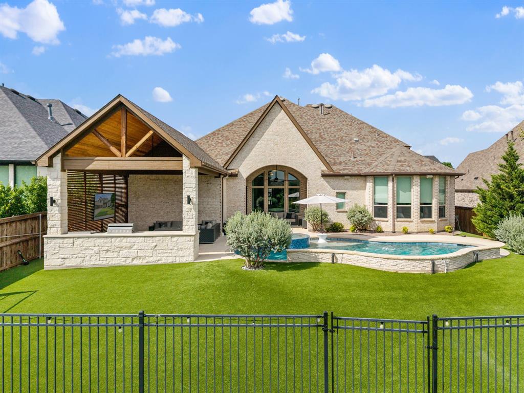 Welcome to this stunning Highland Homes masterpiece in the highly sought-after Trinity Falls community! This thoughtfully crafted floor plan offers luxurious living spaces throughout. Working from home is a breeze in the dedicated office featuring elegant French doors, while movie nights and game days come to life in the downstairs media room located just off the kitchen and living area. The secluded primary suite is tucked away at the rear of the home, creating a private retreat complete with a spa-like ensuite bath. A secondary bedroom with its own full bath is conveniently located at the front of the home. An additional half bath downstairs provides convenience for visitors. The chef-inspired kitchen with huge island and double ovens, opens seamlessly to the main living spaces, creating an ideal setting for entertaining.A spiral staircase leads upstairs to a spacious game room and two additional bedrooms, each offering the privacy and convenience of their own ensuite bathrooms. The oversized three-car tandem garage features durable epoxy flooring, providing both functionality and style. Step outside to your own backyard oasis where a sparkling pool, relaxing spa, and covered outdoor living area overlook a peaceful tree-lined backdrop, offering privacy and a serene setting for year-round enjoyment. Walking distance to Frazier Elementary, pickleball, basketball, playground, and community center with gym! Don't miss out on this one!