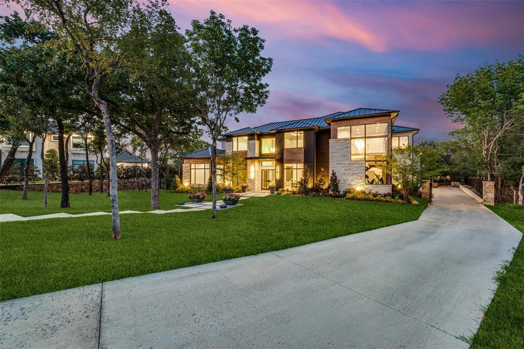 MODERN LUXURY HILL COUNTRY W. 5 CAR GARAGE ON 1.45 ACRE TREED LOT. REMARKABLE  FEATURE  RICH LUXURY HOME has everything with room to spare for living large. RESIDENTS CAN APPLY FOR THE CARROLL ISD.  5 BR, 6.3 Bth, FIVE Car Gar.  . Stone & Ipe wood tile, expansive windows for inside & outside views. Standing seam metal roof and see through 5 car garage for showcasing prized autos from every angle. Electric wrought iron gate entrance & iron fencing surrounding the property.  Two story foyer,  Temp. Controlled Wine Art Display , Club Room with fireplace, large serving bar, and floating glass stairs  with a view from huge staggered corner windows.  Media opens through double doors from club room which is designed for perfect ENTERTAINING. Fml Dining has three dropped stained ceiling panels & windows to floor. Study down w. windows to floor for viewing treed front yard. Open Fam Rm. w. Fireplace  has views of expansive patio and opens to  Kitchen with Professional Appliances  & Catering Kitchen beyond. Expansive patio views of 1.5 acre yard full of trees; has a fireplace and outdoor kitchen, two ceiling heaters, boarded ceiling and tiled flooring creating coziness & scenic privacy.  Master Suite with spa bath & Oversized Wardrobe down + Guest suite w. views & ensuite bath. 2 Utilities Up & Down.  Up is Game w. Balcony & bar area + glass wall viewing Oversized Workout Space +with a large  Balcony & Fireplace beyond with views of heavily treed back yard, sets the stage for luxurious entertainment and serious workouts. Office, GAME EXERCISE RM, 2 COVERED BALCONIES & 3 Bdrms Up, 2 Staircases, Expansive Covered Outdoor Living with Grill & Fireplace.   Energy efficient smart home features beyond your expectations.  Lutron lighting controls, surround sound wiring in family, outdoor areas, game, media, exercise room,  all is expandable w. CONTROL 4. Many more Luxury features await.