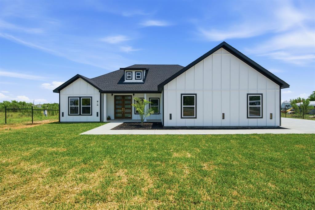 Experience elevated country living in this newly built custom home nestled on 1 acre just beyond city limits. With no HOA and no known restrictions, this property offers the perfect balance of privacy, freedom, and space to create the lifestyle you’ve been dreaming of. Inside, you’ll find a bright open concept layout thoughtfully designed for both everyday living and entertaining. The show stopping kitchen features dual islands, two sinks, a built-in wine fridge, and an effortless flow into the spacious living area. Stylish tile flooring throughout provides durability with a clean, modern feel.
The home’s spa-inspired bathrooms are beautifully appointed with LED mirrors and multiple shower heads, while the impressive 8-foot stained pine doors add warmth and character throughout. Outside, you'll enjoy the covered patio ideal for entertaining or enjoying peaceful Texas evenings outdoors. You'll love the oversized two-car garage with natural lighting, extended driveway, and wide-open acreage that provide endless possibilities for additional parking, hobbies, future additions, or recreational use. Eligible for USDA