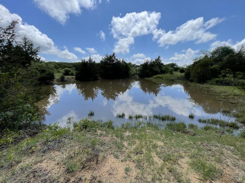 Discover almost 210 acres of prime land, split into two parcels (90.15 and 118.98 acres), offering boundless opportunities for ranching, development, or a private hunting paradise. This breathtaking property boasts approximately 2,600 feet of county road frontage and a private dirt road on the south end providing access to the 90-acre parcel. Combining stunning natural beauty with exceptional privacy, it’s perfect for a peaceful retreat, productive ranch, or smart investment. Enjoy expansive producing pastures, cross fencing, scattered treed areas, and seasonal water tanks that enhance the land’s versatility. Whether you envision a thriving agricultural operation, secluded getaway, or future development, this property delivers unmatched potential.