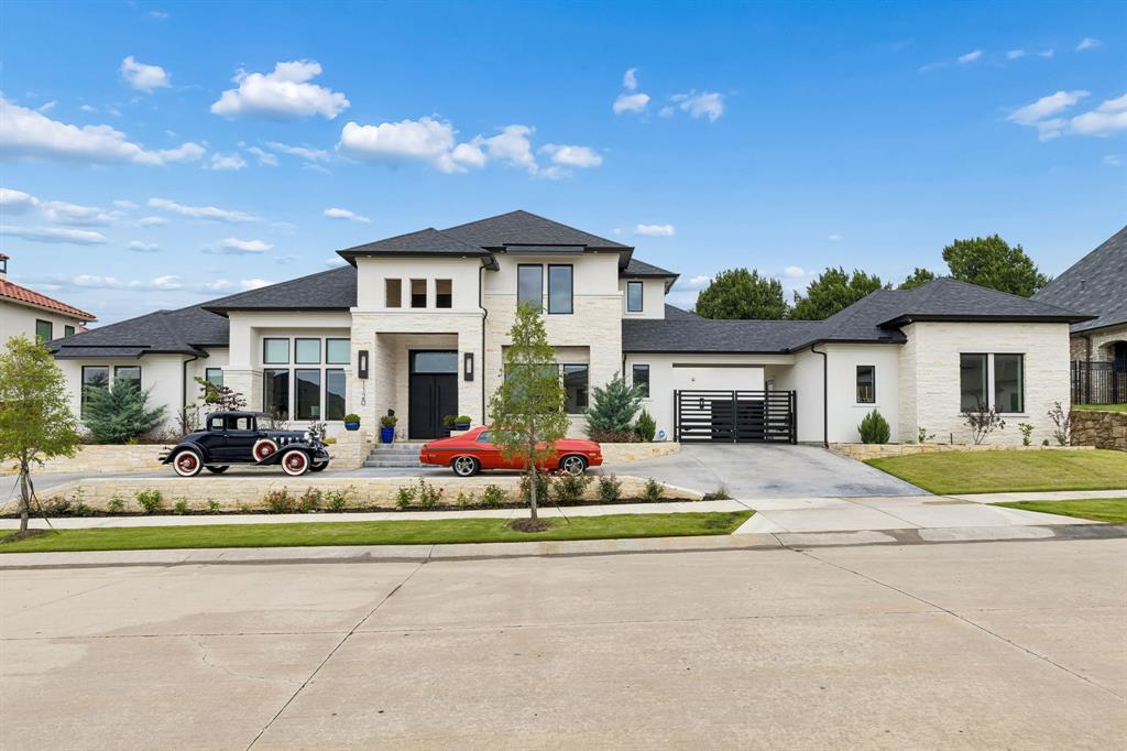 This stunning estate in the exclusive guard-gated community of Enchanted Hill offers the perfect blend of luxury & comfort. Situated with an incredible resort-style backyard and six-car garage, this home was designed for both entertaining and relaxed living. Inside, the home features crisp modern finishes, soaring ceilings & a seamless open floorplan filled with natural light. The grand foyer makes an unforgettable first impression with  dramatic floating staircase & double-sided aquarium. A private office & elegant formal dining room add both style & versatility. At the heart of the home is the impressive family room with sleek contemporary fireplace & expansive views of the backyard oasis. The space flows effortlessly into the kitchen, dining & bar area. The gourmet kitchen is truly a standout, w premium Thermador appliances, massive 14-foot waterfall island, breakfast bar seating & an oversized butler’s pantry w exceptional prep space & storage. The primary suite feels like a retreat, w direct access to pool & spa, a luxurious bath w freestanding tub, oversized shower & dual closets. Two additional bedroom are located downstairs, perfect for guests or multigenerational living. Upstairs, you’ll find 2 additional bedrooms, large game room, home theater, and access to the covered balcony & outdoor living space. This home includes thoughtful everyday conveniences like two laundry rooms, large mudroom, sauna, built-in water dispenser in mud room, gated parking pad & private six-car garages. The backyard is truly the centerpiece of the property, offering a resort-style experience w spectacular pool & spa, fire & water features, expansive covered lounge & dining area & fully equipped outdoor kitchen built for year-round entertaining! Located near Legacy West, The Star, DFW Airport, Highway 121 & I-35, residents also enjoy access to more than 25 parks, pools, sports facilities & a premier private golf course—bringing together luxury living and unmatched convenience.