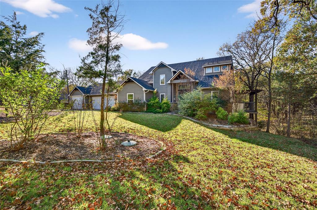 The ultimate lakefront retreat awaits! Lake Views and just Steps Away From the Shore!! Immerse yourself in the serene beauty of this remarkable lakehouse, boasting not just stunning views but direct access to the water. Step inside to discover a sprawling open floor plan, highlighted by expansive upper and lower patios, as well as the off the primary. Feel a sense of living amidst the treetops as the living room seamlessly connects to the patio with retractable doors. Each bedroom features its own attached bathroom. Upstairs, the generously sized bedrooms are complemented by a separate living area. The tandem 4 car garage is perfect for boat storage and all of your lake toys! Sonos surround sound installed in every room, even the garage. This turnkey home comes fully furnished and ready for your immediate enjoyment. This home also presents an excellent opportunity for those seeking a successful short-term rental venture, as it is already listed and thriving in the market.