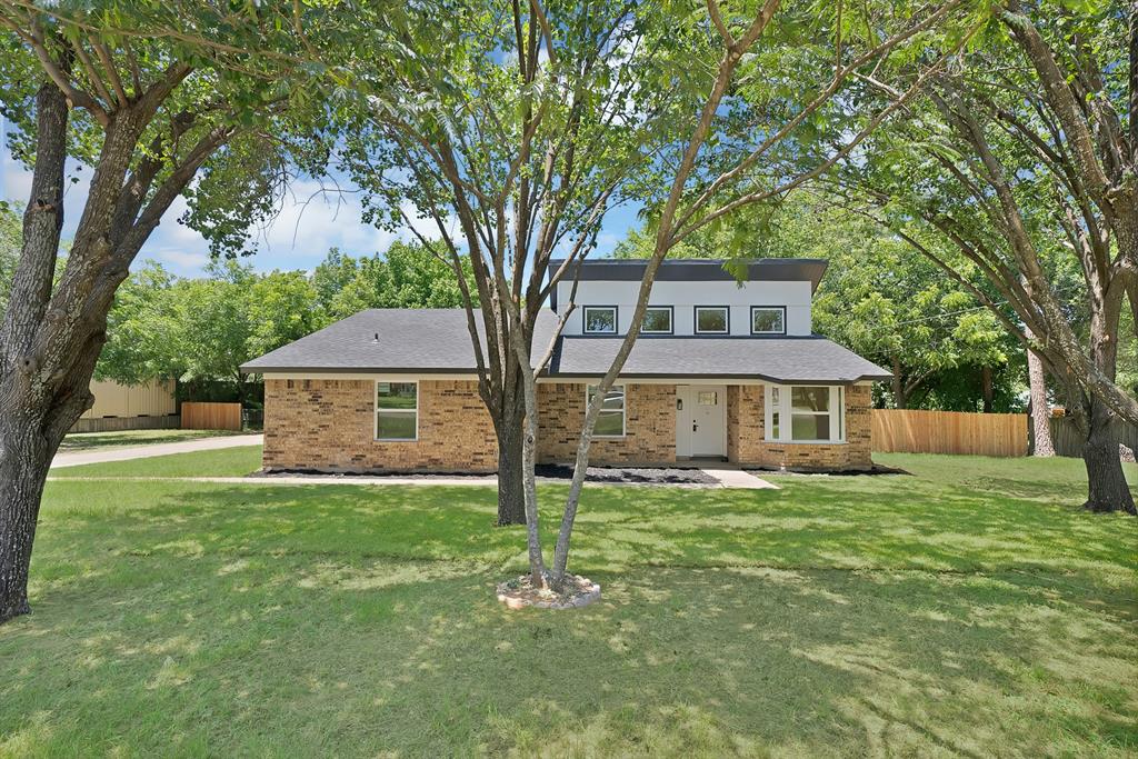 Completely remodeled from top to bottom, this stunning 3-bedroom, 2-bath home with a versatile dining room or flex space offers 1,866 square feet of beautifully updated living space on an oversized, tree-filled lot in the heart of Burleson. The extensive renovation includes new windows, a new HVAC system, new flooring throughout, new interior doors and trim, updated plumbing and lighting fixtures, and beautifully remodeled bathrooms, creating a truly move-in-ready home. Step inside to soaring vaulted ceilings with clerestory windows, a dramatic floor-to-ceiling brick fireplace, luxury vinyl plank flooring, and an open, inviting layout filled with natural light. The beautifully redesigned kitchen features quartz countertops, custom shaker cabinetry, stainless steel appliances, and stylish modern finishes. The spacious primary suite offers a stunning, fully remodeled ensuite bath with designer tile, while the attached garage features new Wi-Fi-compatible garage doors for added convenience. Outside, the expansive backyard is shaded by mature trees, providing plenty of room to relax, entertain, or play. In addition to the attached garage, you'll also find an oversized detached two-car garage with a two-car carport, offering exceptional space for vehicles, hobbies, a workshop, or extra storage. The detached garage has also been refreshed with new drywall, paint, and garage door making it an ideal space for projects, storage, or additional workspace. Offering timeless character, modern design, and exceptional functionality on an incredible oversized lot, this beautifully renovated home is a rare find in one of Burleson's most established neighborhoods.