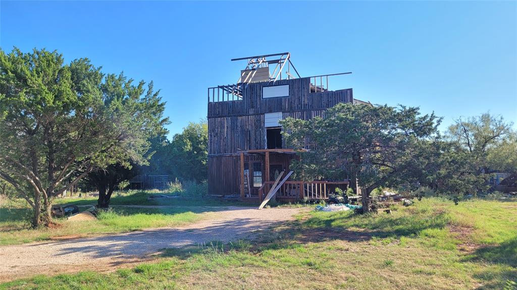 What a great way to have your dream home. Either by starting over from scratch on nearly an acre in the rolling hills of Buffalo Gap in the highly desired Jim Ned School District or rolling up your sleeves and building a home that suits you. Currently constructed as a 3 story 1880's architecture with modern materials, this under construction home could be finished out to your liking. Walk in from a stained-glass front door to a 35x18 sized living area with a wood burning stove, vaulted ceiling, and large width real hardwood floors. Many unfinished rooms could be reconfigured the way you would want like the office or other floors. Plumbing has been run for a second master suite area. The lot boasts oak and fruit trees attracting local deer and wildlife. Come take a look at this opportunity!