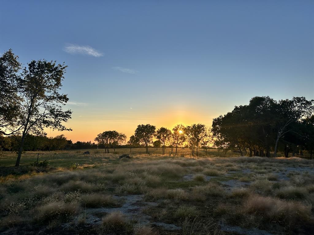 This is the perfect spot to build your dream home in the highly sought after Gunter ISD with current Ag exemption with bees. Property has 2 gravel roads....one that leads to the already existing building pad that boasts an unbelievable view and one that leads to the existing shop located at the back of the property. There is a 60x50 metal shop that has electricity and water. The shop also has a second story storage loft, one side that is climate controlled, spray foamed, extra tall ceilings and 3 garage style doors. Located outside city limits with utilities installed. Come take a look and make these beautiful sunsets your daily view!

See MLS #20863841 for an additional acreage for sale.