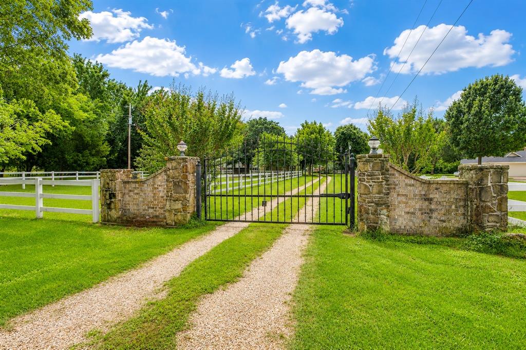 Experience the perfect blend of country living and modern comfort with this stunning 2-bedroom, 2.5-bath custom home on 5.38 fully fenced acres. Offering 2,429 sq ft, this spacious 2-story home is ideal for horse lovers, hobby farmers, or anyone seeking a private retreat with room to roam. A gated entrance welcomes you to beautifully maintained acreage featuring mature pecan trees, fruit trees, blackberry bushes, cross fencing, and a pond.

Downstairs offers a versatile media room, secondary living area with a cozy propane gas stove fireplace, and an enclosed back patio complete with a built-in grill—perfect for entertaining year-round. Upstairs you’ll find gorgeous wood floors, a formal dining area with office space, and a spacious living room that opens seamlessly to the kitchen featuring granite countertops, stainless steel appliances, breakfast bar, and eat-in dining area.

The primary suite includes a spa-like en-suite bath with jetted soaking tub, separate shower, and walk-in closet. The guest bedroom features a private outdoor terrace to enjoy your peaceful morning cups of coffee. 

Equestrian-ready with a professional 2-stall barn, fenced pasture, heated water troughs, and two concrete-floor tack rooms. Additional improvements include a heated and cooled chicken coop, two utility loft barns, RV hookups with parking, and multiple workshop-game room opportunities. The detached garage with water, electric, and mini split AC makes an ideal workshop, game room, or hangout space, while the separate cottage with AC, water, and electric is perfect for a home office, craft room, or business space.

A rare Texas acreage property offering privacy, functionality, and endless possibilities.